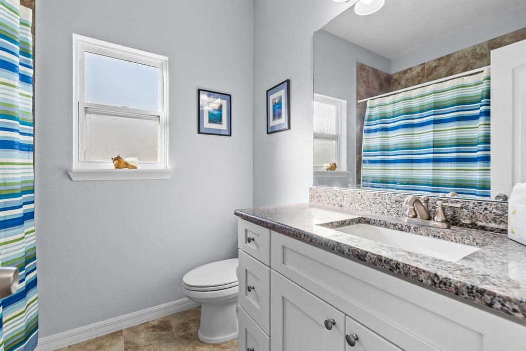 124 Dory Road St. Augustine, FL 32086 - Photo 22 of 39 a bathroom with a granite countertop sink toilet and mirror
