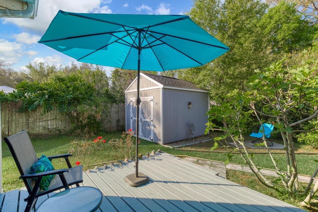 124 Dory Road St. Augustine, FL 32086 - Photo 30 of 39 a view of a table and chairs under an umbrella