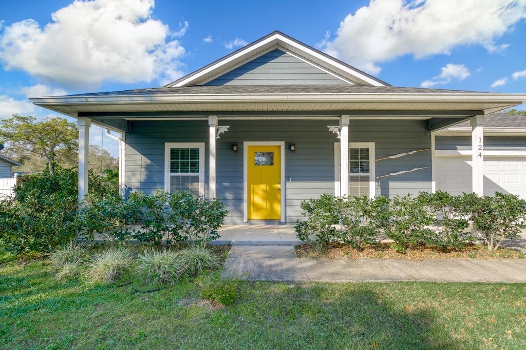 124 Dory Road St. Augustine, FL 32086 - Photo 3 of 39 a front view of a house with garden