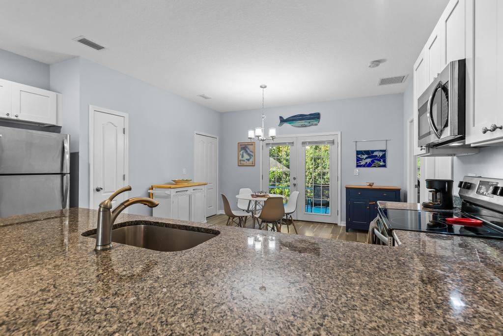 124 Dory Road St. Augustine, FL 32086 - Photo 10 of 39 a kitchen with stainless steel appliances granite countertop a sink refrigerator and cabinets