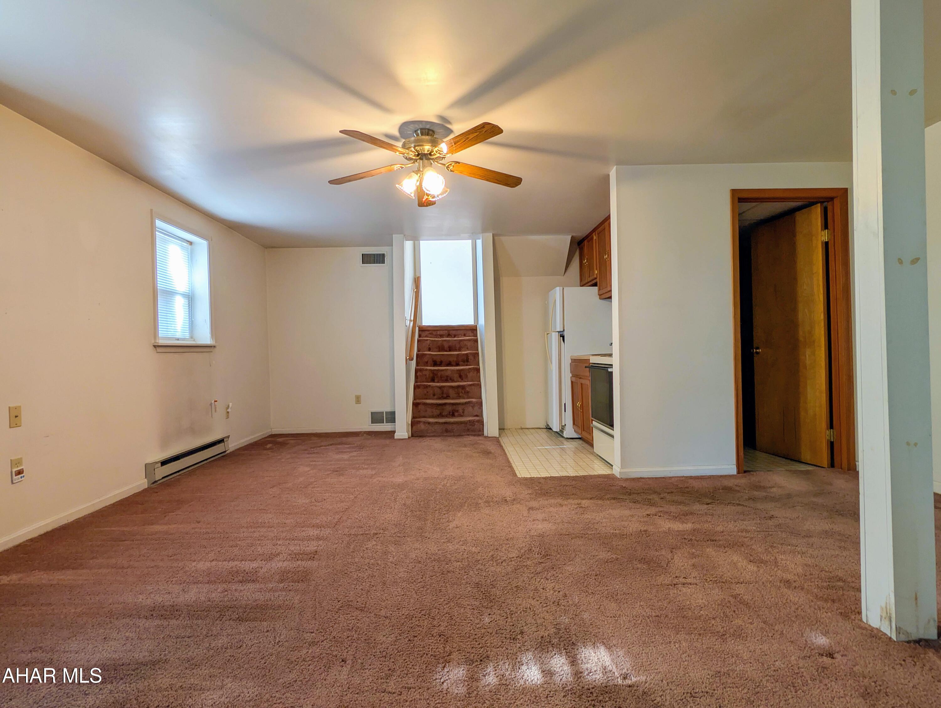 147 Pine Street Hyndman, PA 15545 - Photo 24 of 44 an empty room with chandelier fan and windows