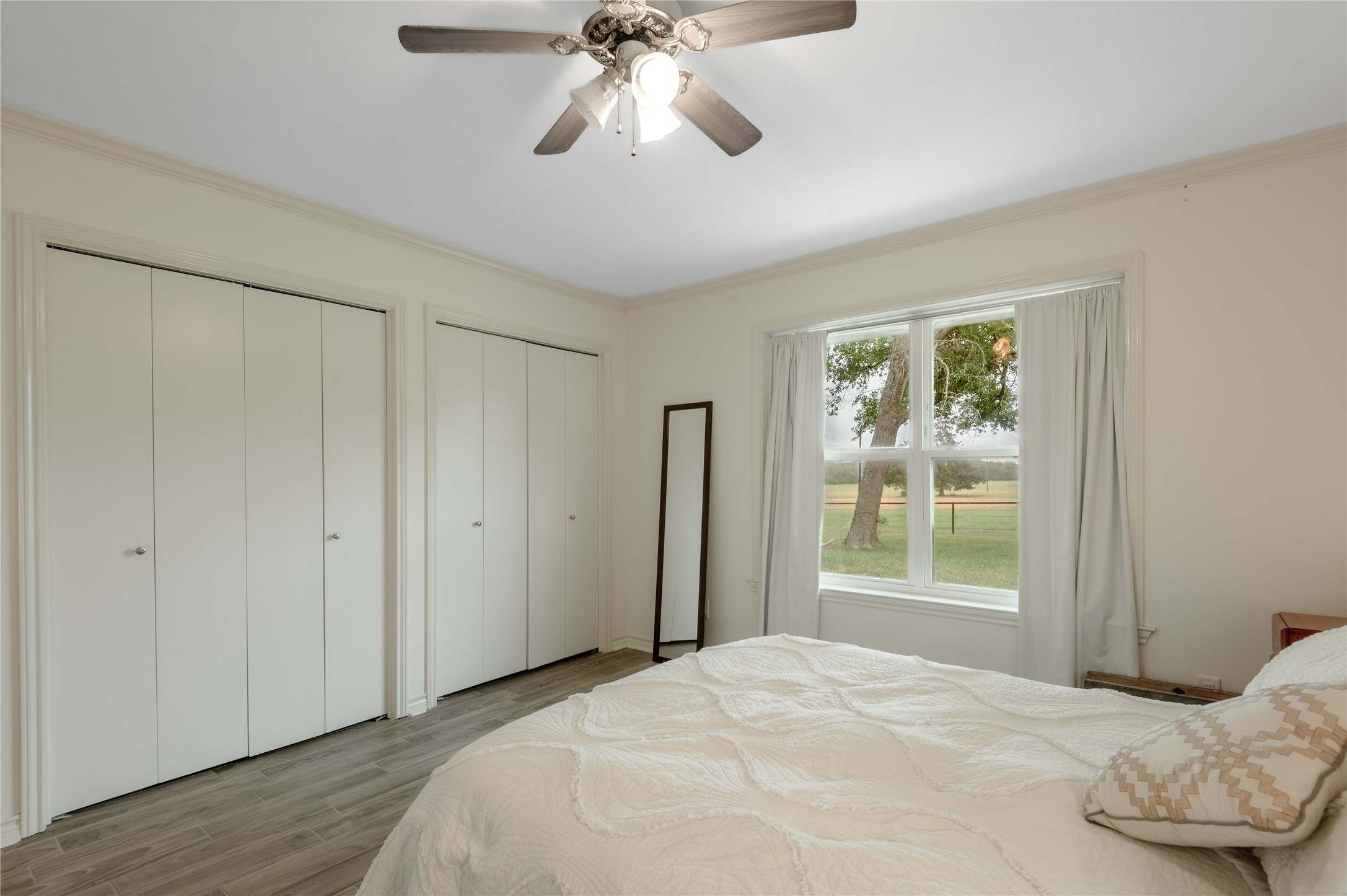 758 Wire Road Huntsville, TX 77320 - Photo 10 of 44 a bedroom with a bed and a window