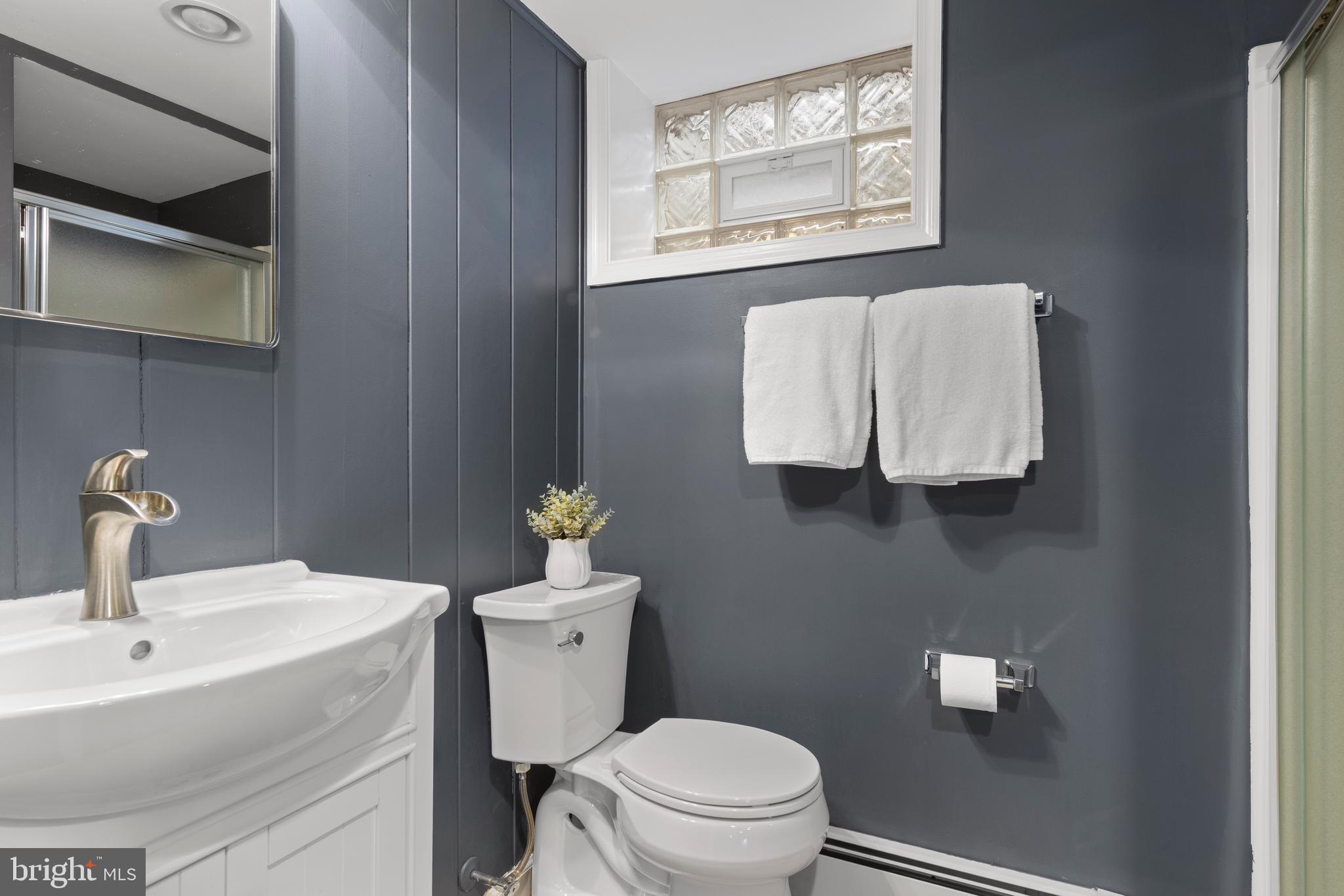 152 Hunters Lane Devon, PA 19333 - Photo 57 of 57 a bathroom with a toilet sink and mirror