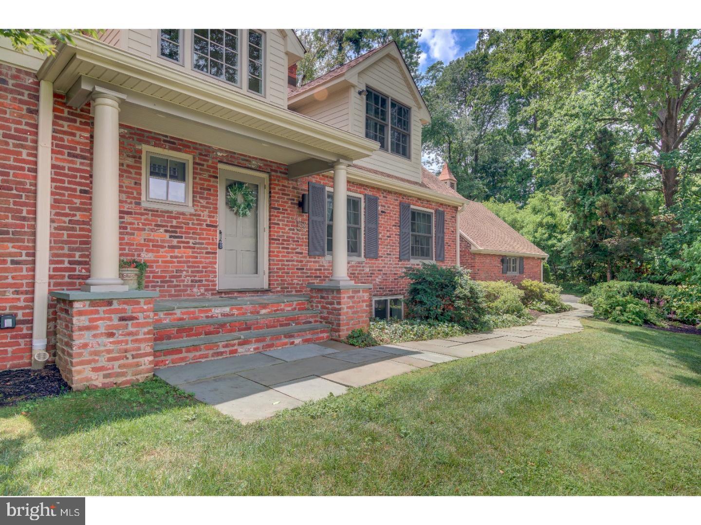 152 Hunters Lane Devon, PA 19333 - Photo 7 of 57 a view of a house with brick walls and a yard with plants