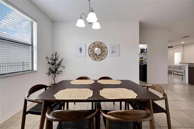 a view of a dining room with furniture and chandelier
