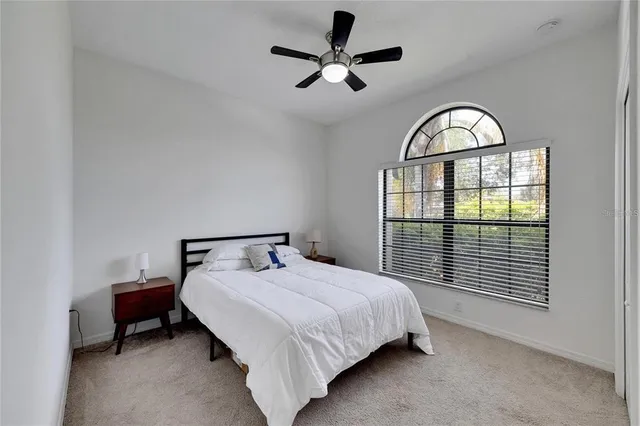 a bathroom with a sink a toilet a mirror and shower