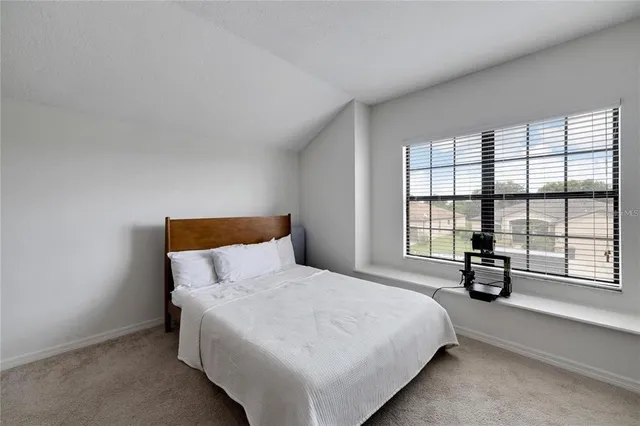 a bedroom with furniture and windows