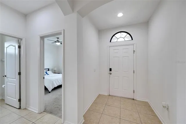 a view of a hallway with closet and bathroom