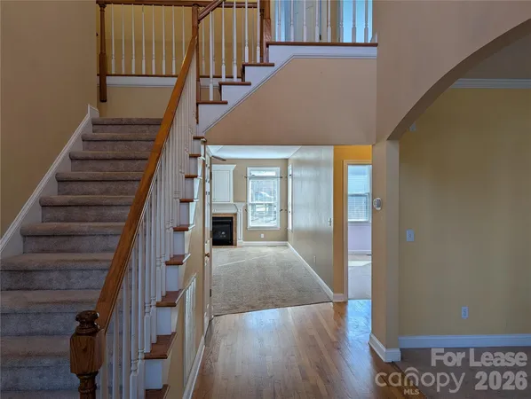 a view of entryway and hall with wooden floor