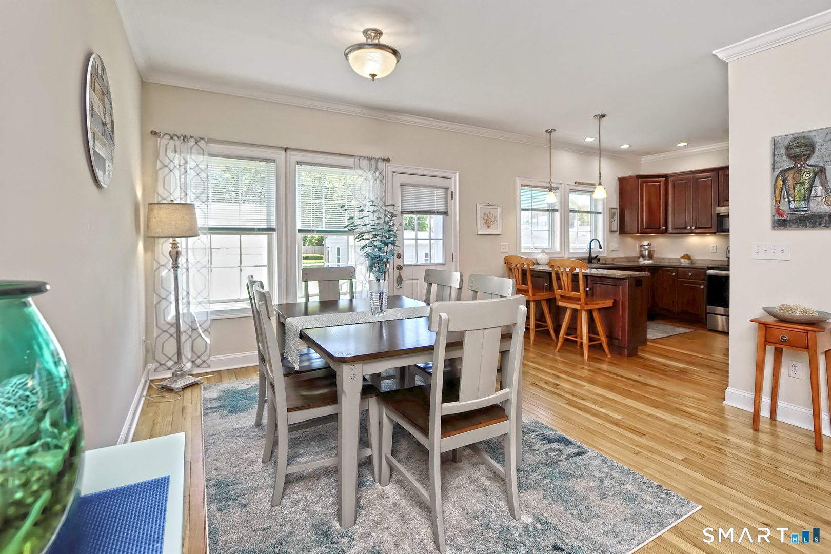 102 Lantern Court, Unit 102 Clinton, CT 06413 - Photo 14 of 36 a view of a dining room with furniture window and wooden floor