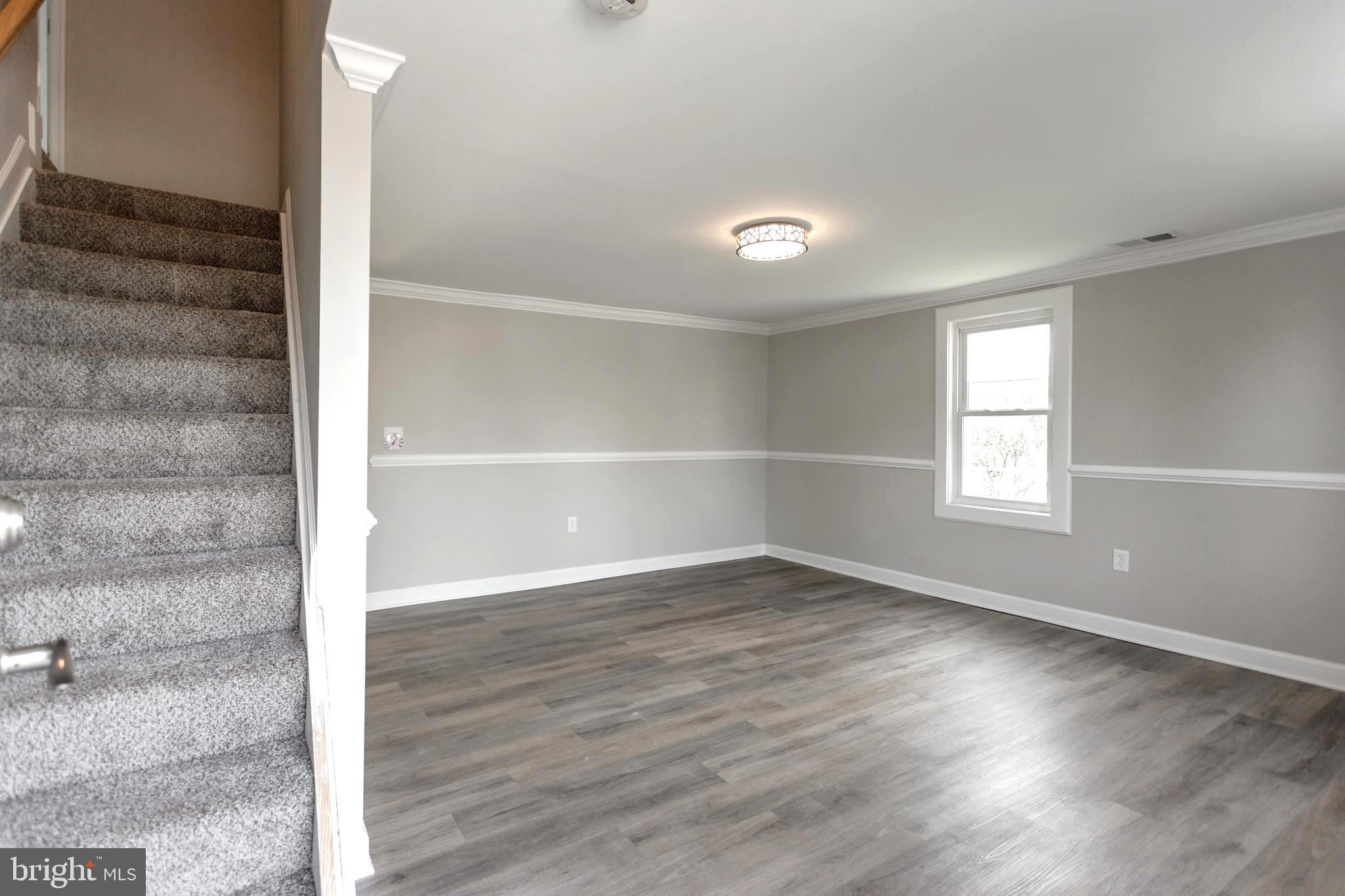 2087 Park Trail Road Windsor Mill, MD 21244 - Photo 12 of 32 Open living room, crown moulding, chair rail trim