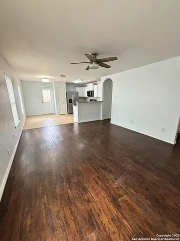 a view of a kitchen with a sink and wooden floor