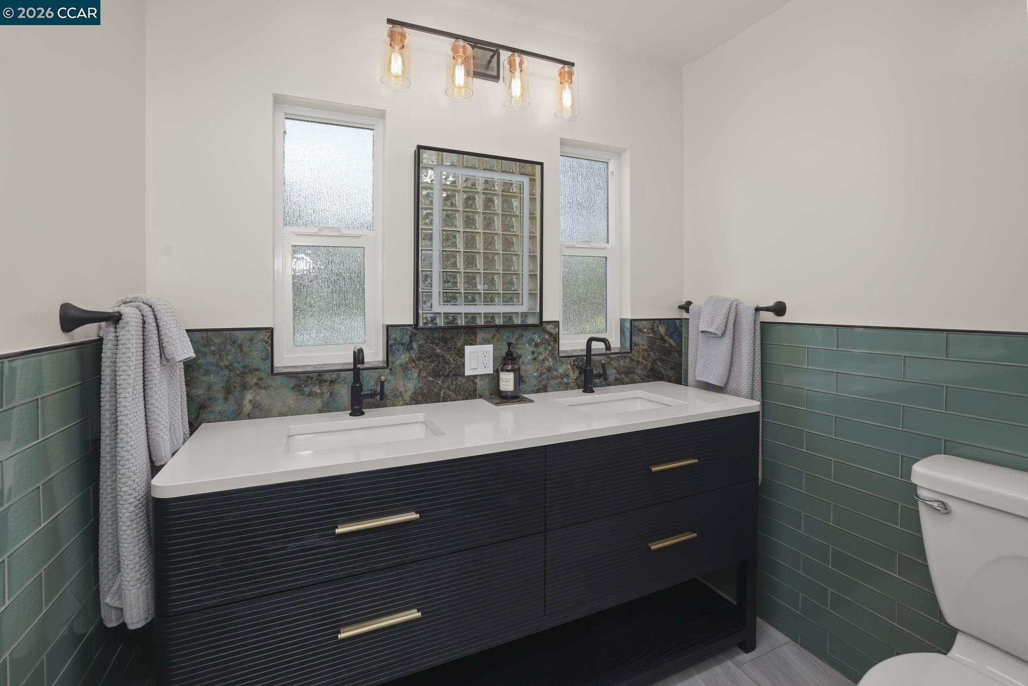 1051 San Rafael Street San Leandro, CA 94577 - Photo 21 of 26 a bathroom with a granite countertop sink mirror and toilet