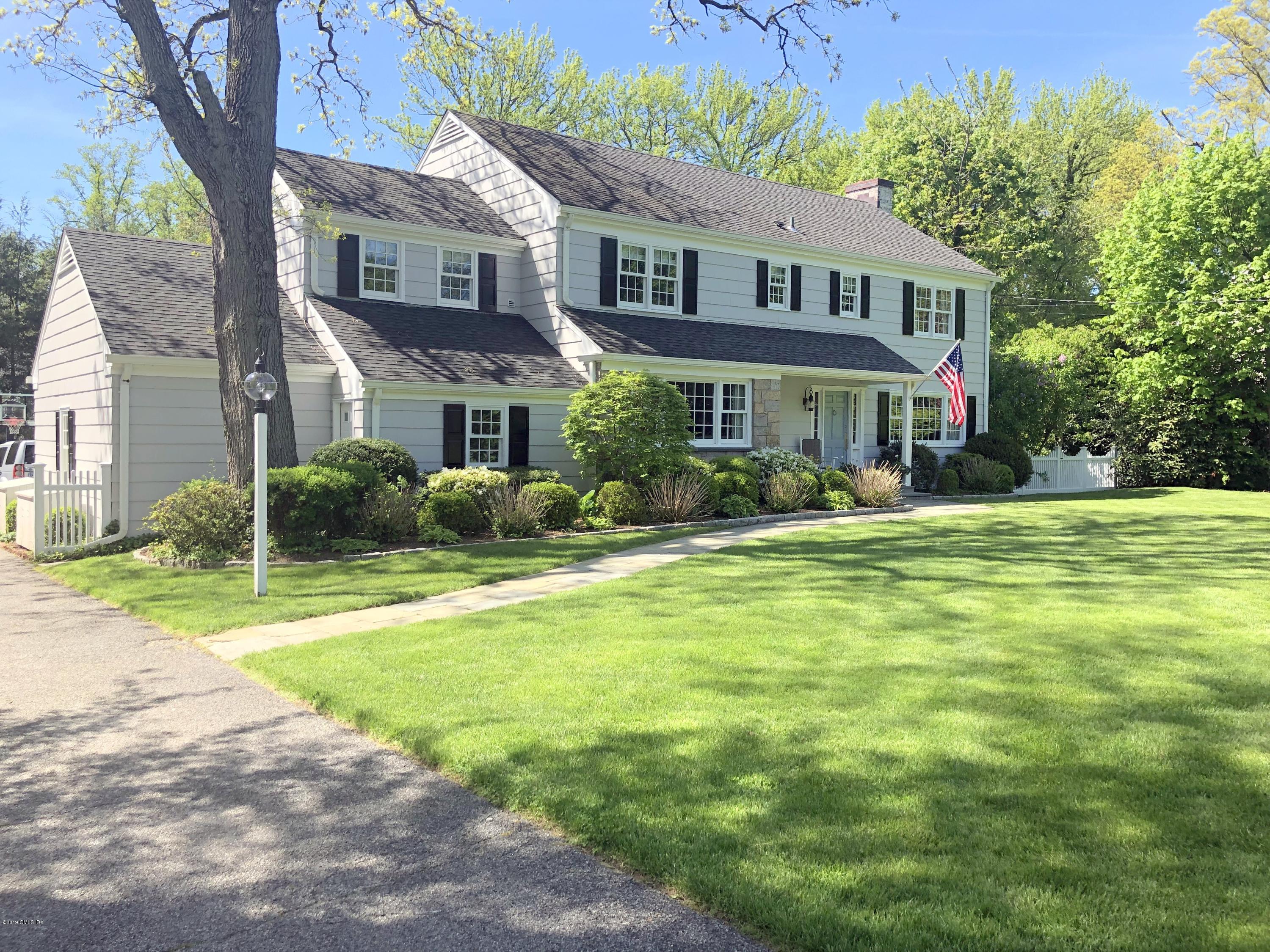 a front view of house with yard and green space