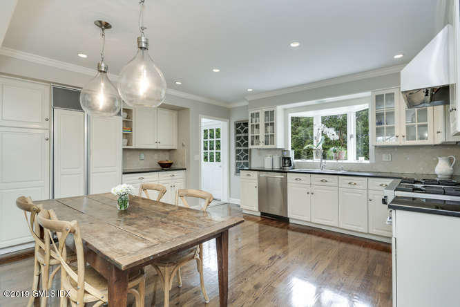 110 Meadow Road Riverside, CT 06878 - Photo 11 of 38 a kitchen with kitchen island a counter top space a sink stainless steel appliances and cabinets