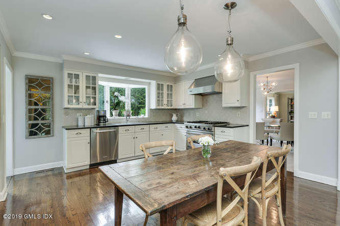 110 Meadow Road Riverside, CT 06878 - Photo 12 of 38 a kitchen with a table chairs and wooden floor