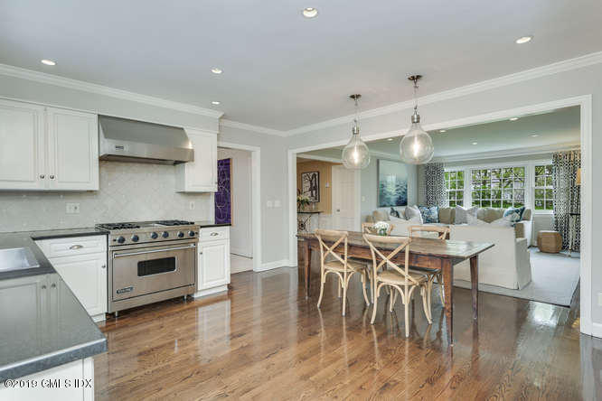 110 Meadow Road Riverside, CT 06878 - Photo 13 of 38 a kitchen with stainless steel appliances a dining table and chairs