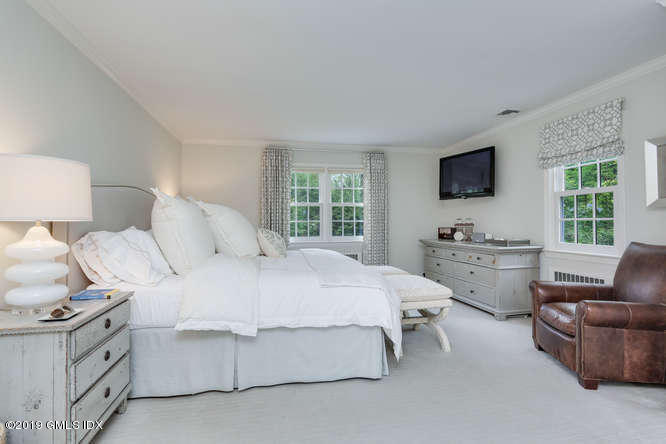 110 Meadow Road Riverside, CT 06878 - Photo 19 of 38 a bedroom with bed and flat screen tv