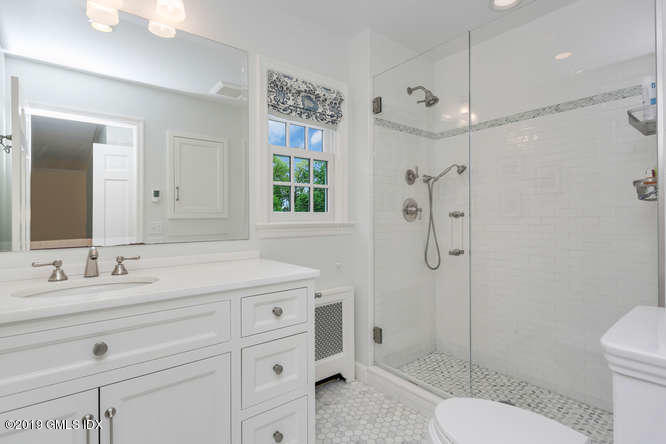 110 Meadow Road Riverside, CT 06878 - Photo 21 of 38 a bathroom with a granite countertop sink toilet a mirror and shower