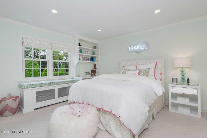 110 Meadow Road Riverside, CT 06878 - Photo 22 of 38 a bedroom with a bed and a large window