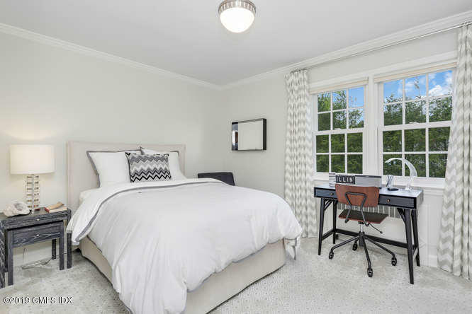 110 Meadow Road Riverside, CT 06878 - Photo 23 of 38 a bedroom with a bed and a table