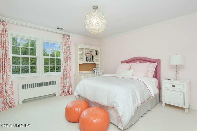 110 Meadow Road Riverside, CT 06878 - Photo 24 of 38 a spacious bedroom with a bed and a large window