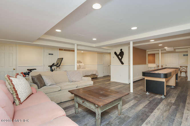 110 Meadow Road Riverside, CT 06878 - Photo 28 of 38 a living room with furniture a rug and a chandelier