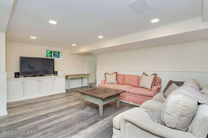 110 Meadow Road Riverside, CT 06878 - Photo 29 of 38 a living room with furniture and a flat screen tv