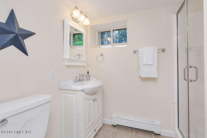 110 Meadow Road Riverside, CT 06878 - Photo 32 of 38 a bathroom with a sink a toilet and a mirror