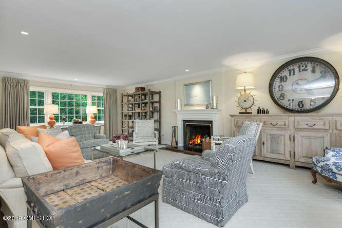 110 Meadow Road Riverside, CT 06878 - Photo 7 of 38 a living room with furniture a fireplace and a large window