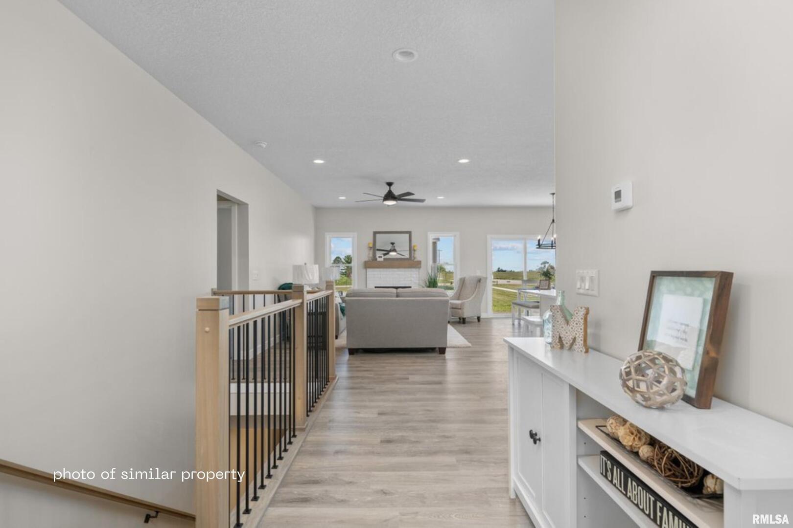 1867 Redbud Circle, Unit 102 Eldridge, IA 52748 - Photo 2 of 15 a living room with furniture and a wooden floor
