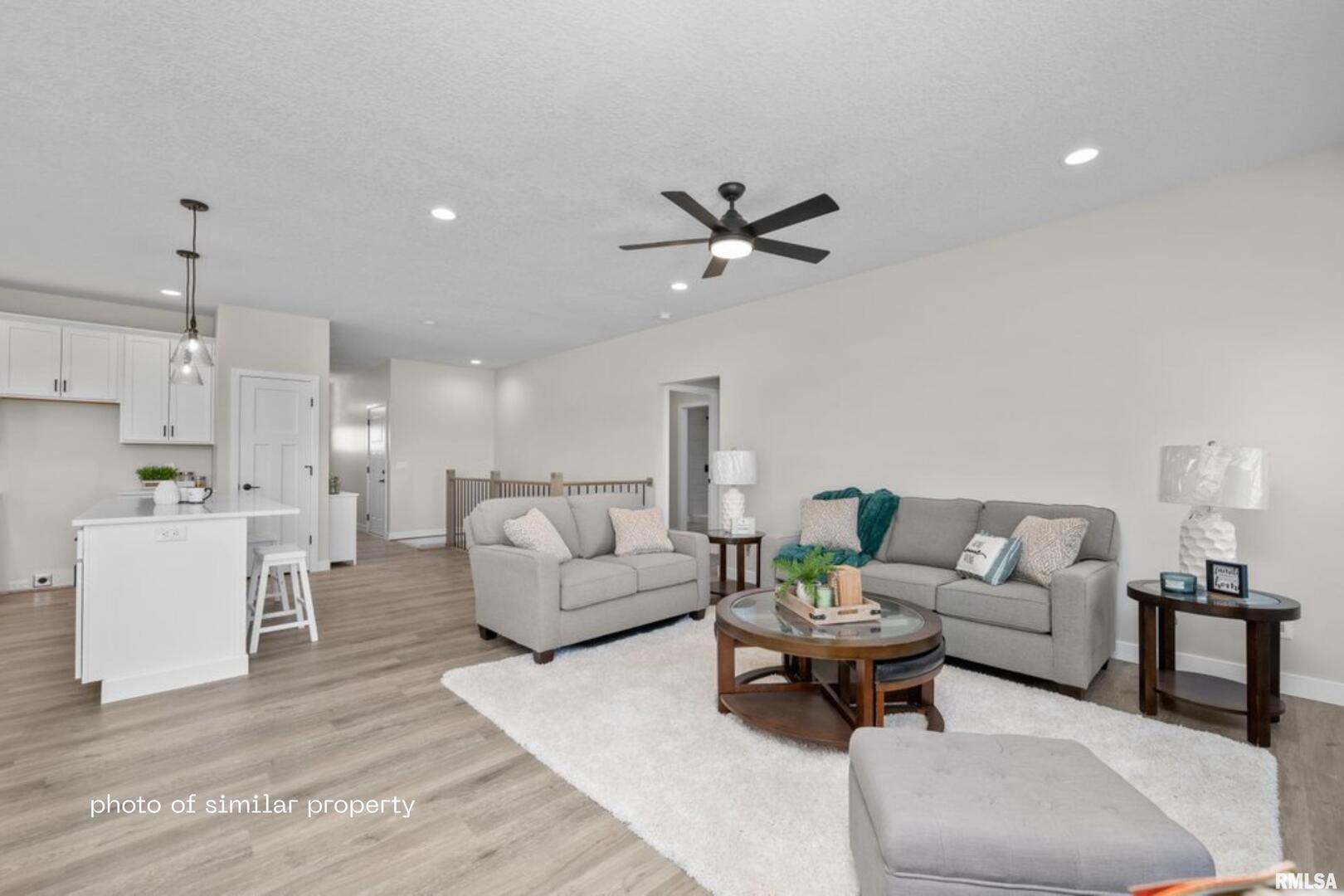 1867 Redbud Circle, Unit 102 Eldridge, IA 52748 - Photo 4 of 15 a living room with furniture a view of bedroom and a couch