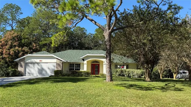 a aerial view of a house with garden and trees