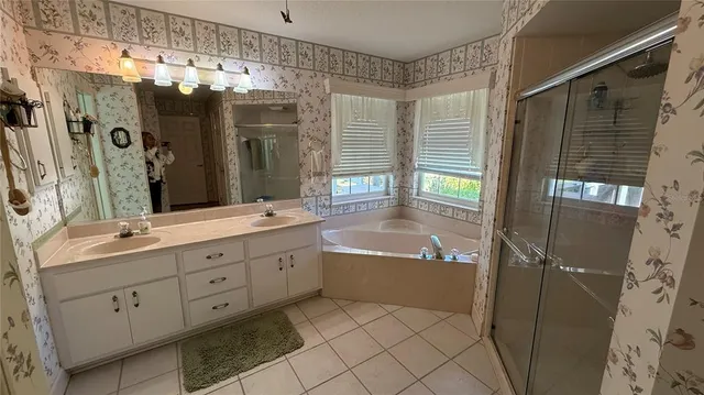 a bathroom with a granite countertop sink mirror and a bathtub