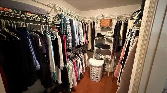 a close view of walk in closet with clothes