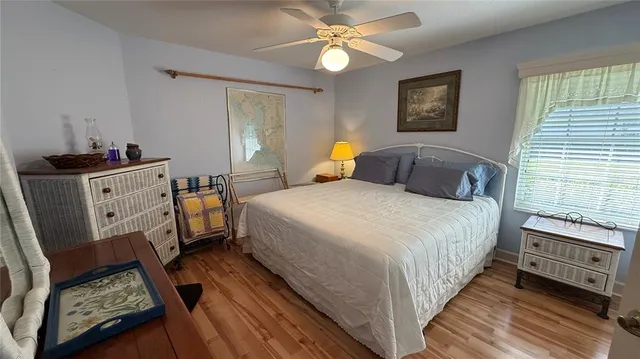 a bedroom with a bed dresser and a window