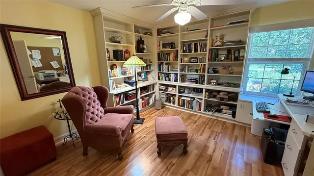 a living room with furniture and a book shelf