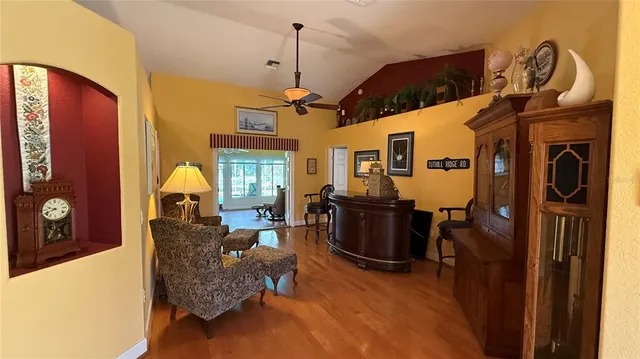 a living room with furniture a window and a chandelier