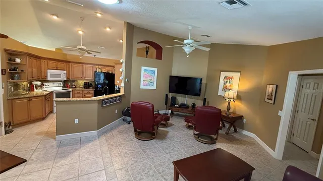 a kitchen with stainless steel appliances granite countertop a sink dishwasher stove top oven and cabinets