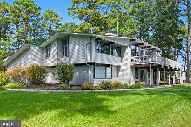 a view of a patio with table and chairs potted plants and large tree