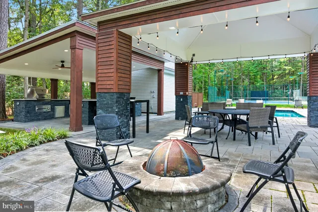 a dining room with stainless steel appliances kitchen island a table and chairs