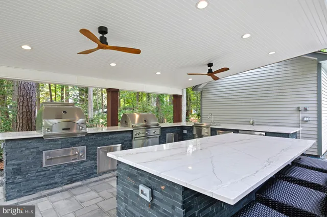 a living room with furniture floor to ceiling window and a flat screen tv