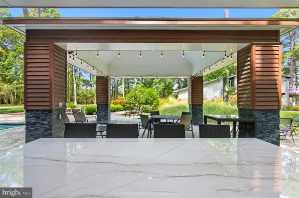 a dining room with a large window table and chairs