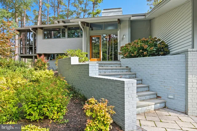a bedroom with a bed and glass window