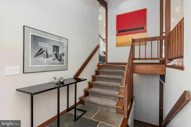 a bedroom with a bed and glass window