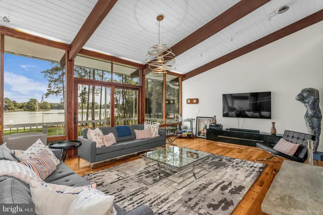 a bedroom with a bed and a dresser next to a window