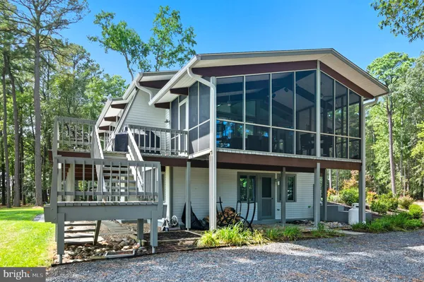 a view of house with swimming pool and porch