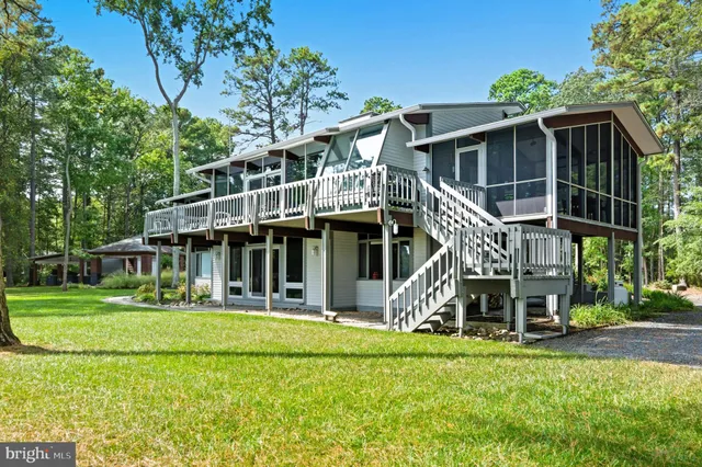 a view of a lake with a bench and trees around