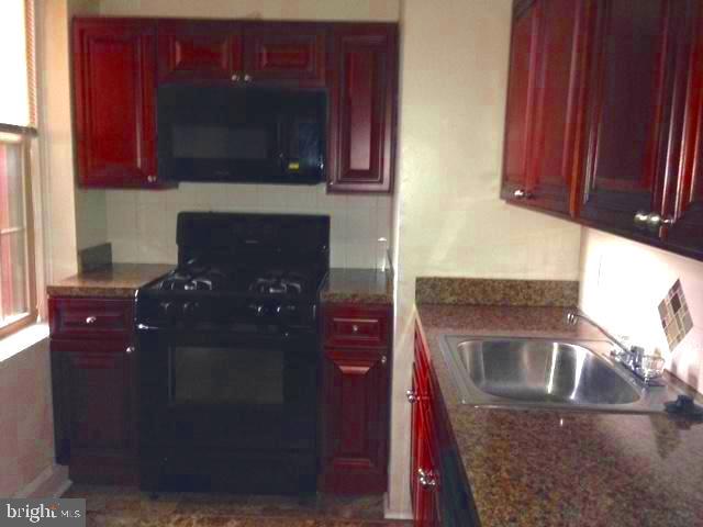 a kitchen with stainless steel appliances granite countertop a refrigerator and a microwave