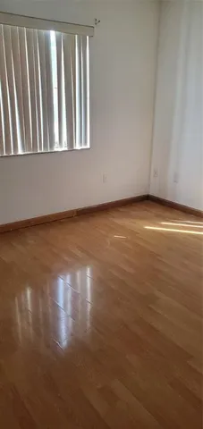 a view of wooden floor and a window